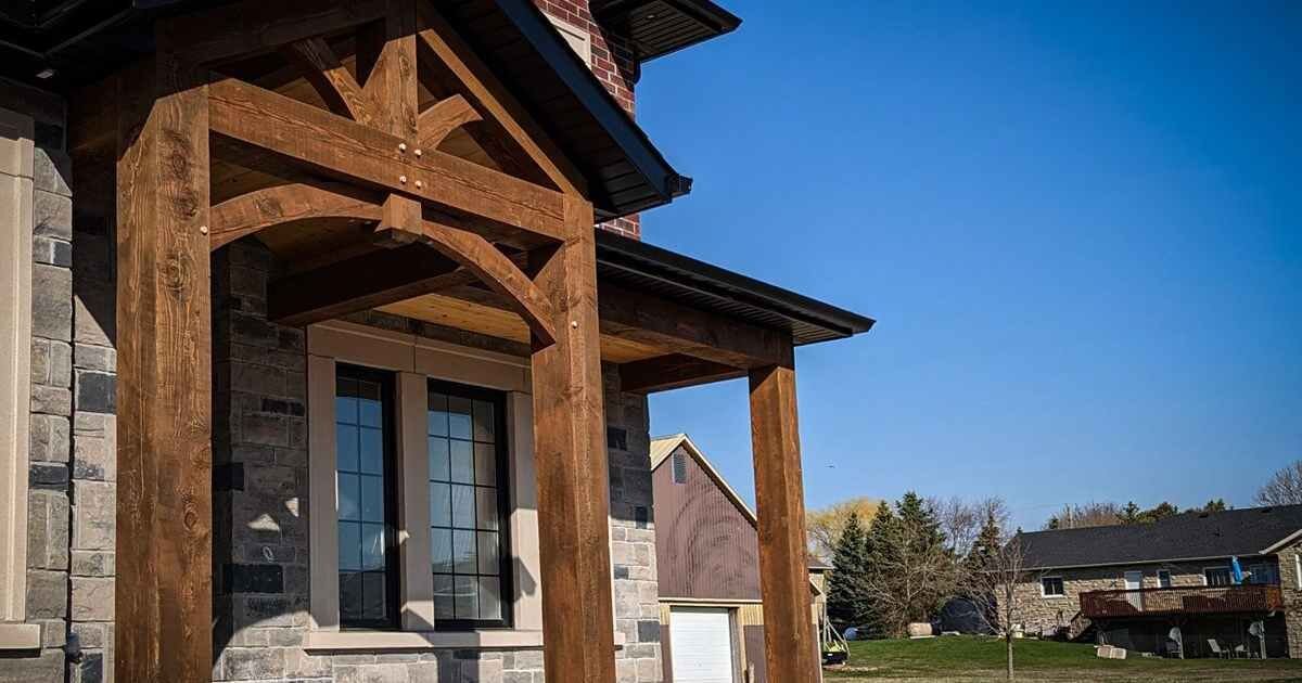 Rustic timber entryway on a stone-front house